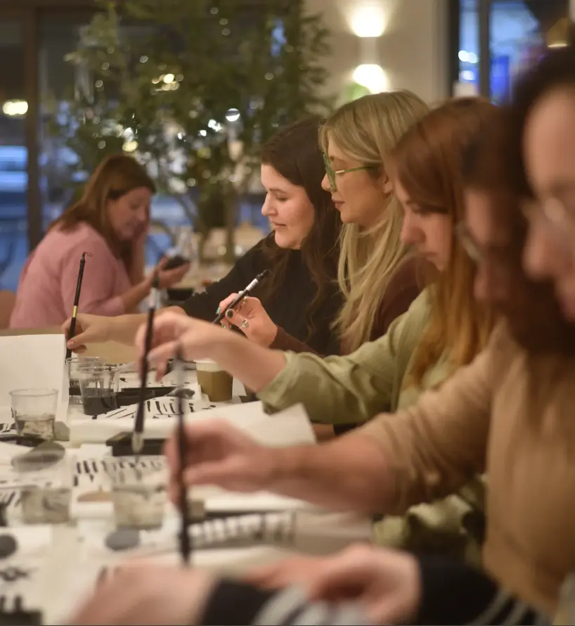 A close-knit BonBon group painting together during an Artivian Sumi-e workshop