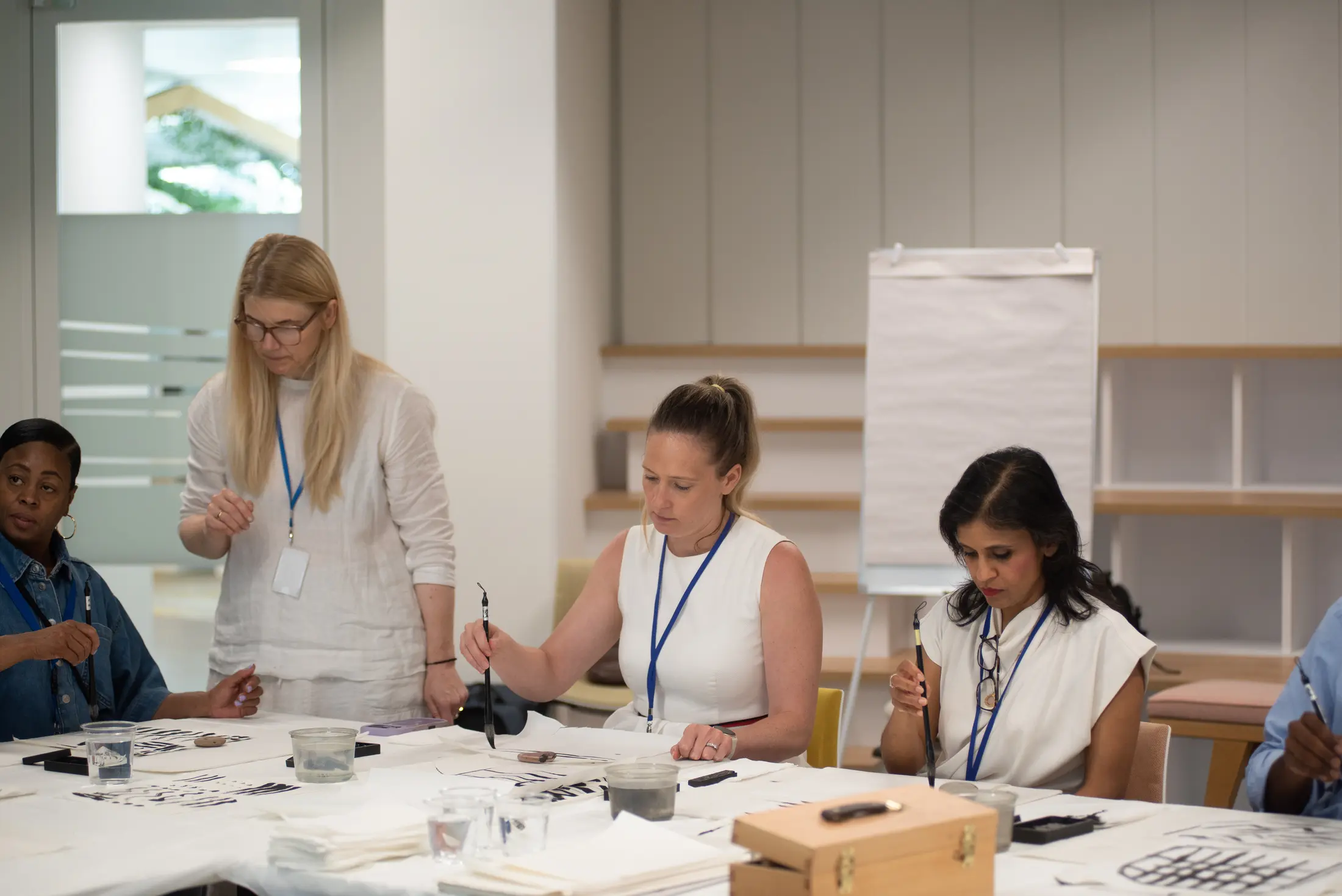 Corporate team learning Sumi-e Japanese ink painting with Artivian